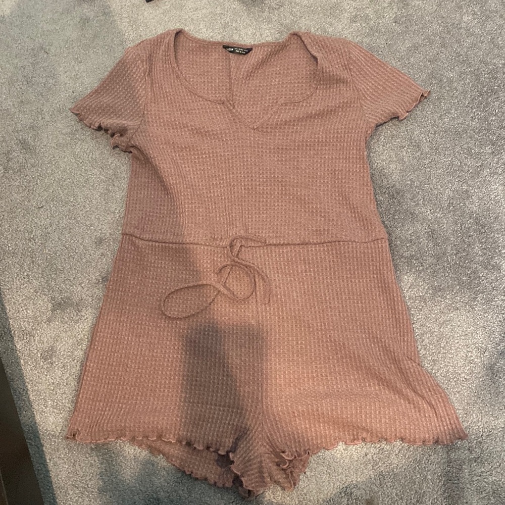 Pink Romper with built in shorts, shirt sleeve and tie in the front